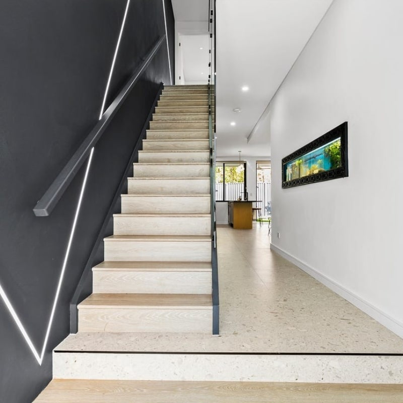 A modern hallway with stairs inside a home at 12 Pillars Place, Matraville — designed and built by Sydney East Building & Renovations.