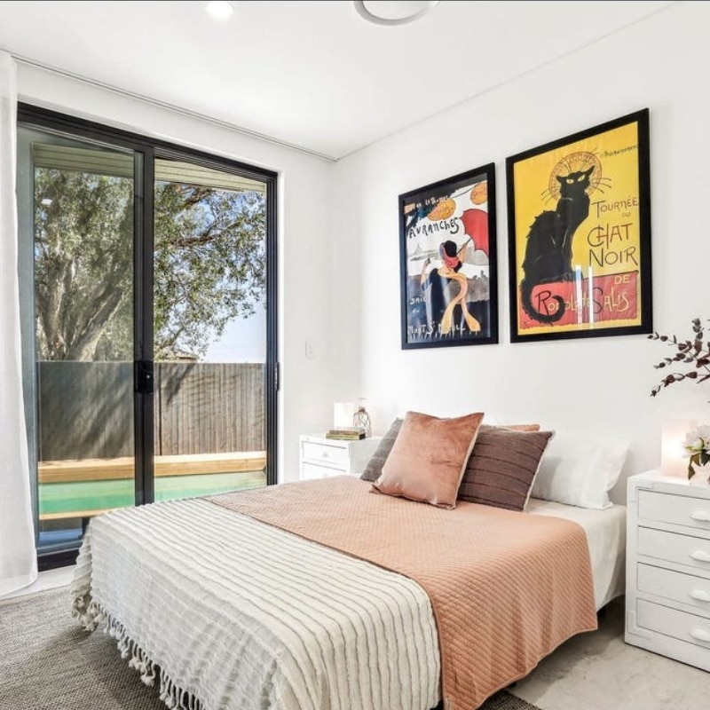 Cosy bed with white, brown, and khaki pillows inside a modern duplex at 55 Eyre Street, Chifley, 2036 – completed by Sydney East Building & Renovations.