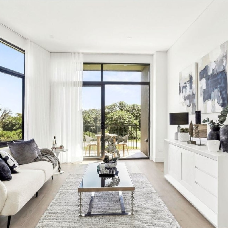 Nice weather, sala set room with a white couch and pillows at 55 Eyre Street, Chifley, 2036 – Duplex by Sydney East Building & Renovations.