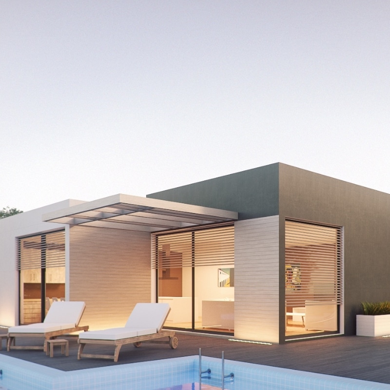 Single storey home builders Sydney team at work. Single Storey Homes – Modern house exterior with large windows, wooden accents, and poolside loungers, softly lit during the evening
