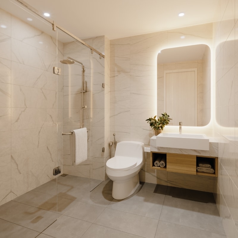 Why choose Sydney East Building Renovations – Modern bathroom with glass shower, toilet, sleek sink, warm lighting, and natural accents including a plant