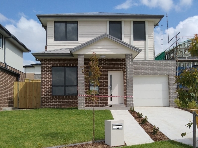 Newly built suburban double storey home with garage and front yard