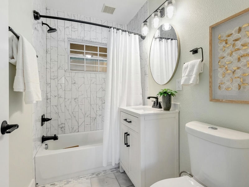 Completed old bathroom renovation with new vanity, shower, and toilet.
