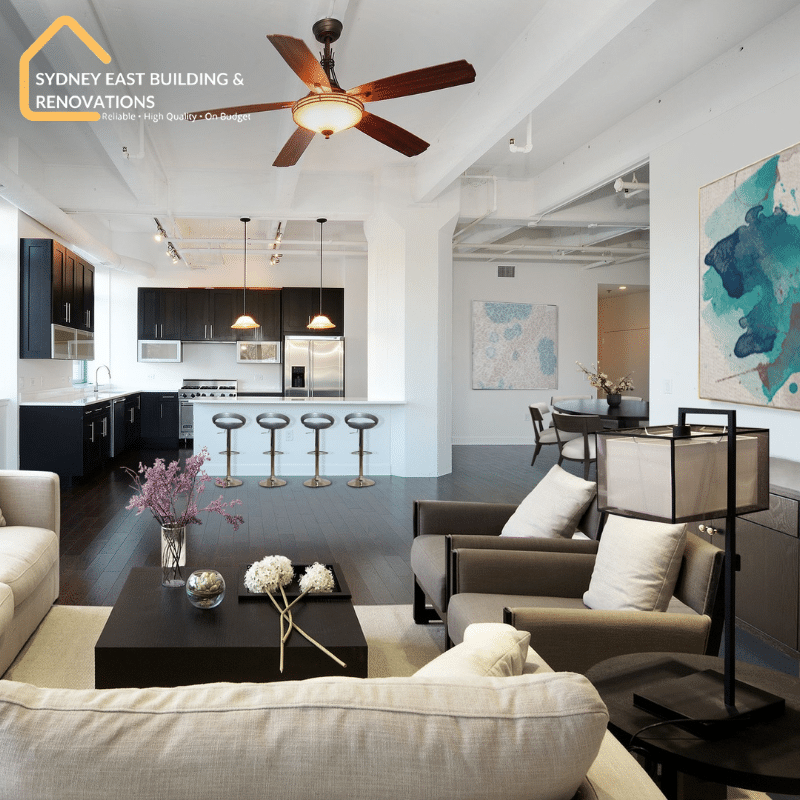 Modern open-concept living room and kitchen upgraded with home renovation services in NSW, featuring sleek finishes and contemporary style.