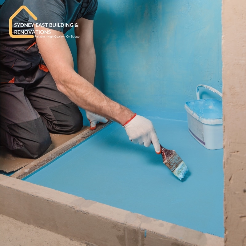 Professional waterproofing Centennial Park experts sealing a bathroom floor for long-lasting protection.